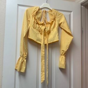 Golden yellow no brand tag on long sleeve blouse.